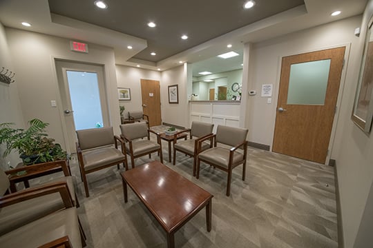 Office waiting room with a table surrounded by chairs